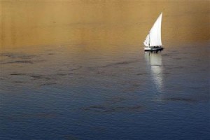 Traditional Egyptian "Felucca" boat sails on the Nile river in the southern Egyptian city of Aswan